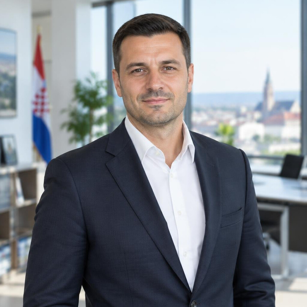 Confident middle-aged businessman in a suit standing in a modern office