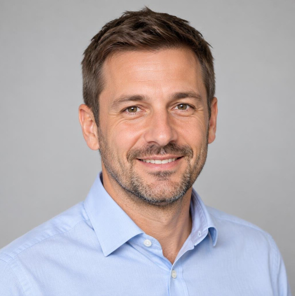 Portrait of a smiling man in a shirt with a neutral background